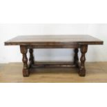 An oak drawleaf Dining Table in the 18th Century style with cleated top on baluster supports and
