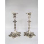 A pair of mid 18th Century silver-form Paktong Candlesticks with knopped stems and petal bases,