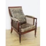 A Regency mahogany Library Bergere Chair, the shaped moulded back and upholstered arms above a