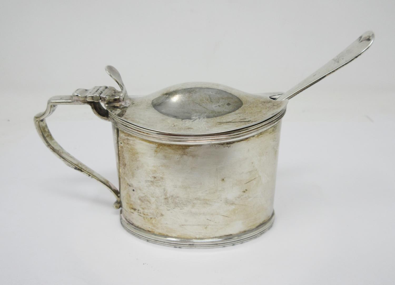 A George III silver oval Mustard Pot with hinged lid engraved crest, London 1796, hinge A/F and a la