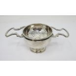 A modern silver heavy two handled Tea Strainer and Stand, London 1977/8