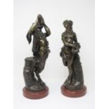 A pair of bronze Ewers with decorative handles having cherub mounts, cherubs in band around centre