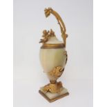 A marble and gilded bronze Vase and Cover, the cover mounted with a cherub reaching for a grapevine,