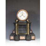 A black slate Empire style Mantel Clock by Duplan & Salles with embossed panels depicting Putti