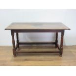 An 18th Century oak Dining Table, the three plank cleated top above a moulded freize on turned