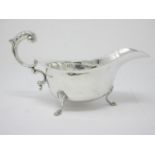 A George V silver Sauce Boat with leafage scroll handle on hoof feet, Birmingham 1932, 134gms
