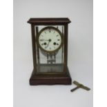 A 19th Century French mahogany and glazed Mantle Clock with brass beading and enamel dial with Roman