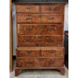 An early 18th Century walnut Chest of two short and three long cross-banded drawers, on stand with