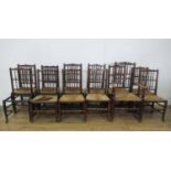 A set of twelve 19th Century spindle back Dining Chairs with rush seats on turned front legs