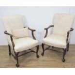 A pair of mahogany framed Elbow Chairs with upholstered backs and seats on cabriole front supports