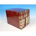 A red lacquered Korean Travelling Box with decorative pierced and engraved brass fitting, having