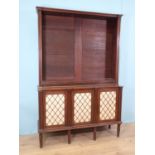 A Regency mahogany open Bookcase with adjustable shelves upon base fitted three brass lattice and