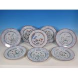 A set of eight Famille verte Plates, decorated flowers and insects with underglaze blue borders, 9in