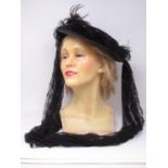 An early 20th century wax mannequin Head with blonde hair and a 1920's style Hat