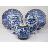 A pair of 19th Century Chinese blue and white lidded Jars with figures within landscapes (one rim