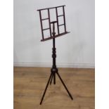 An Aesthetic movement mixed wood adjustable Music Stand on three turned supports