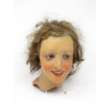 An early 20th Century female wax mannequin Head with plaited brown hair and brown eyes