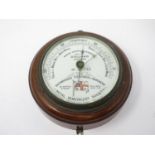 An oak cased circular Marine Aneroid Barometer by Dollond, London, No 733, 'The Shipwrecked