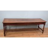 An 18th Century French cherry Farmhouse Table with cleated three plank top mounted upon turned