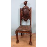 A Continental walnut Chair in the 17th Century style with tooled leather armorial back panel,