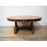 A Regency rosewood Centre Table with moulded oval top, raised on cheval base of two painted and