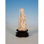 An early 20th Century ivory Figure of a sage holding a staff with pierced and engraved detail on a