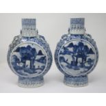 A pair of Chinese blue and white Moon Flasks with designs of figures in landscapes, 10 1/2 in H, one