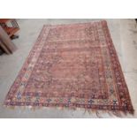 An old bordered Kazak type Rug with triple lozenge having latchhooks, 6ft 9in x 9ft 4in, worn