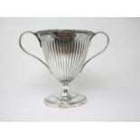 A silver Vase of fluted form with later handles and rim, on oval base, 7 in