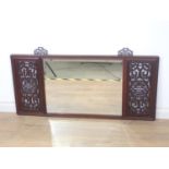 A Chinese rosewood framed Mirror with pierced design incorporating bats to the corners flanking a