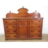 A 19th Century elm Dresser with raised back, fitted central panelled door, flanked by eight