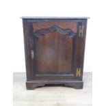 An antique oak Cupboard, the single door with fielded panel enclosing a shelf and panelled to the