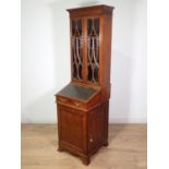 A Victorian mahogany Davenport Bookcase of elegant proportions, the upper section fitted pair of