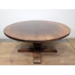 A Trevor Lawrence oak circular Dining Table on squared baluster column and cross supports, 5ft 6in