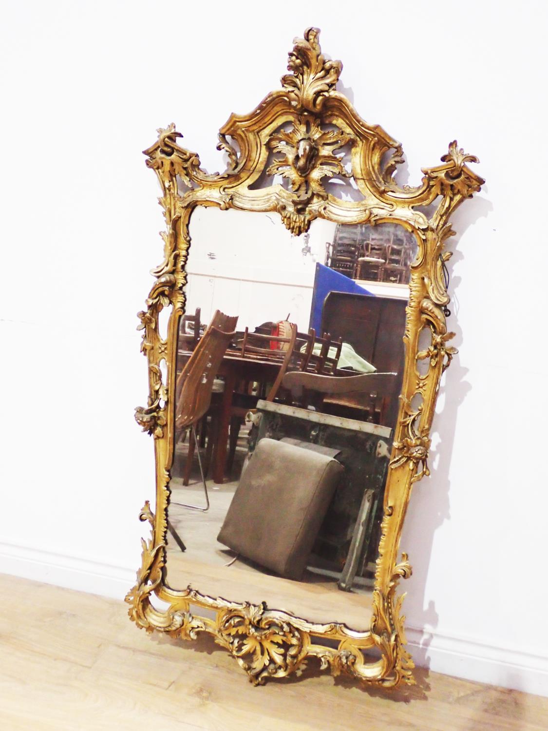 A 19th Century gilt Wall Mirror in the rococo manner with asymmetrical leafage scroll surmount and