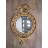 A 19th Century gilt Convex Wall Mirror with eagle surmount and ball frieze, 3ft 7in H