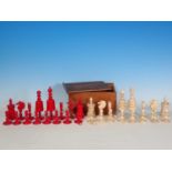 A carved and turned bone Chess Set in red and natural, King 4 1/2in H, in box, one red knight