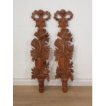 A pair of 19th Century carved pine Wall Appliques with tied ribbon crests above trailing flower