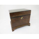 A walnut Jewel Box with hinged lid enclosing tray and small inlaid compartment on ogee bracket feet,
