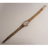 A 1970's lady's Tissot manual Wristwatch, the silvered oval dial with hourly baton markers on