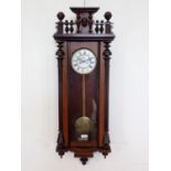 A 19th Century Vienna Wall Clock with white enamel dial, two train weight driven movement, the