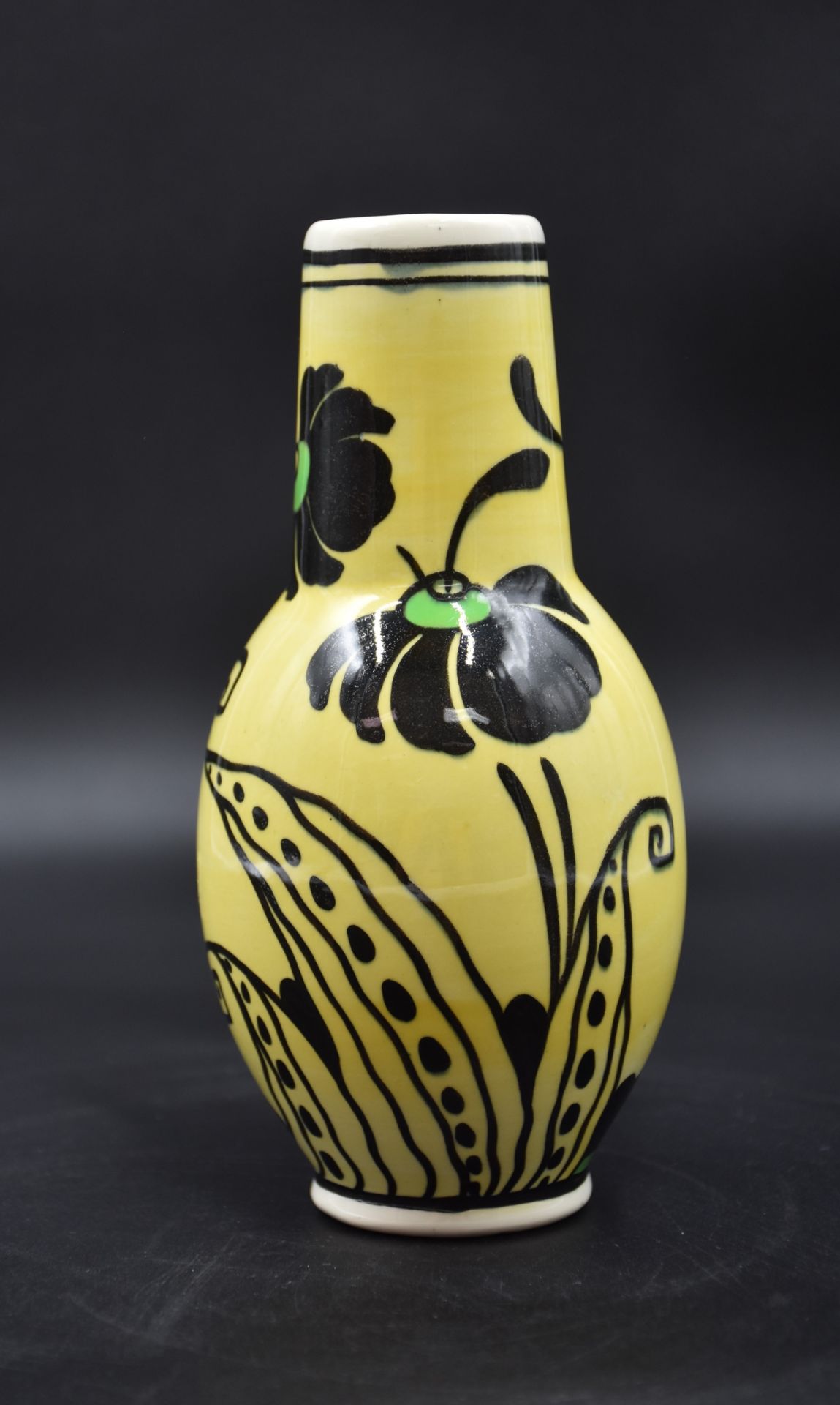 Boch Keramis vase decorated with stylized flowers on a yellow background. Height : 18 cm.