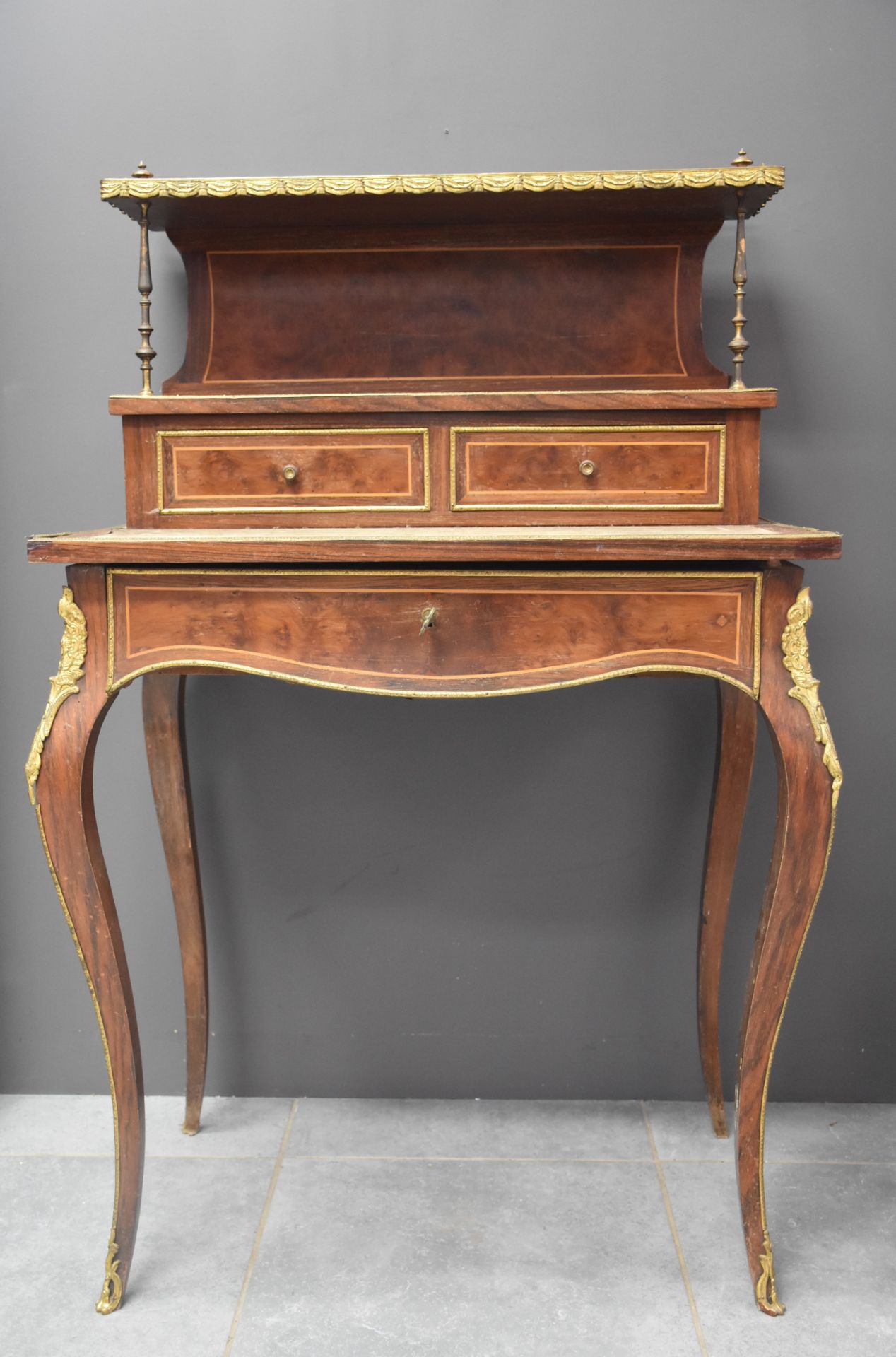 Napoleon III style stepped lady's desk. French work in veneer and bronze ornaments. Height: 116 cm.