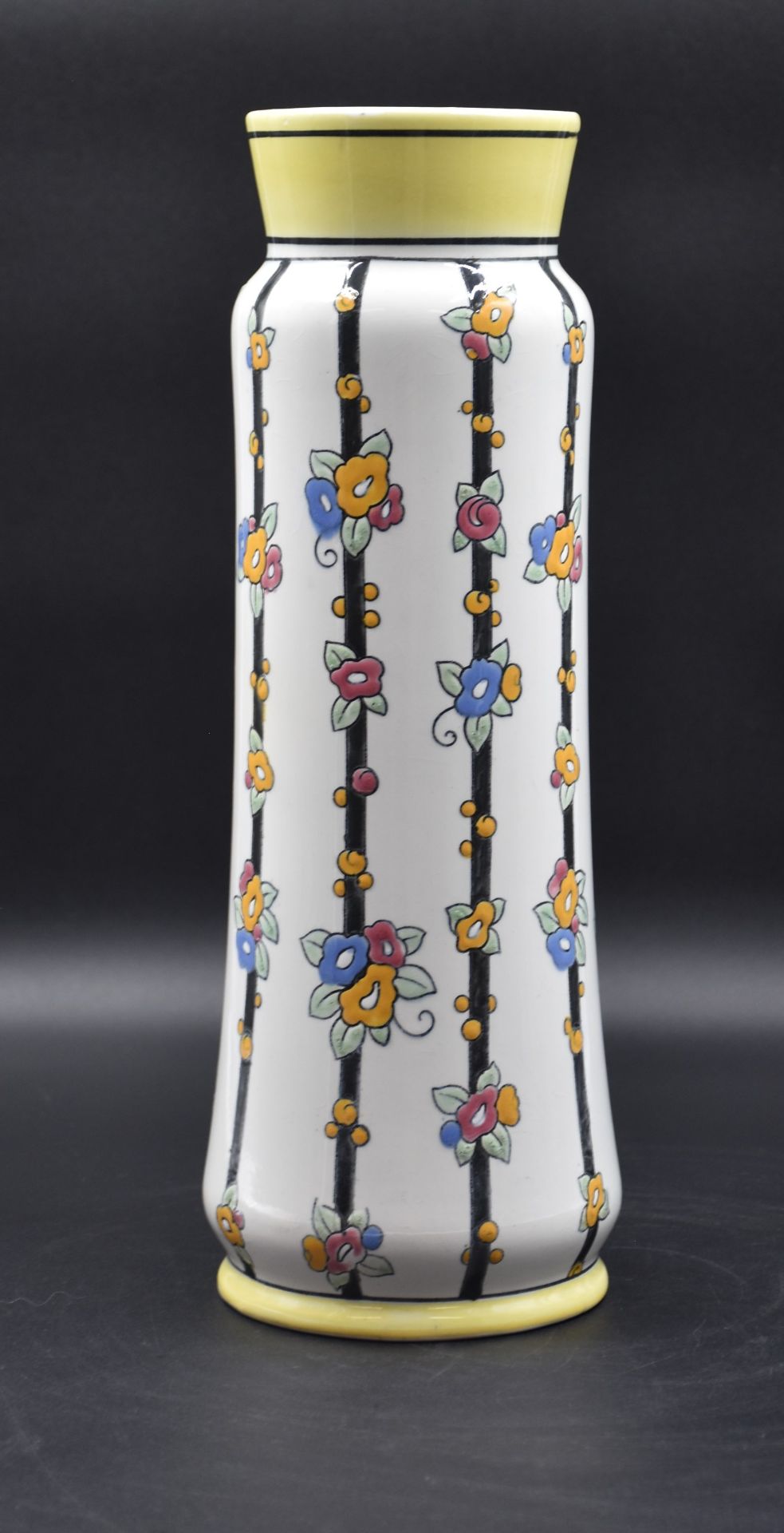 Boch Keramis vase decorated with vertical black bands adorned with stylized bouquets. Height: 38 cm.