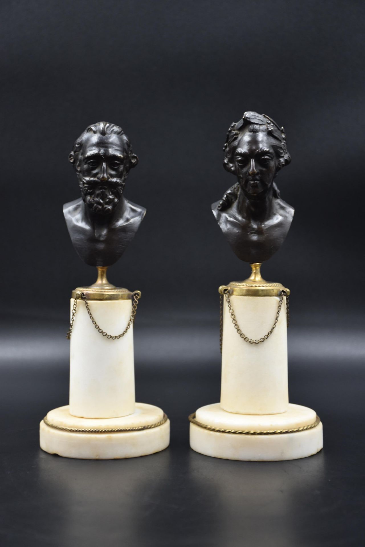 Pair of 18th century bronze busts, white marble bases representing Henry IV and an illustrious chara