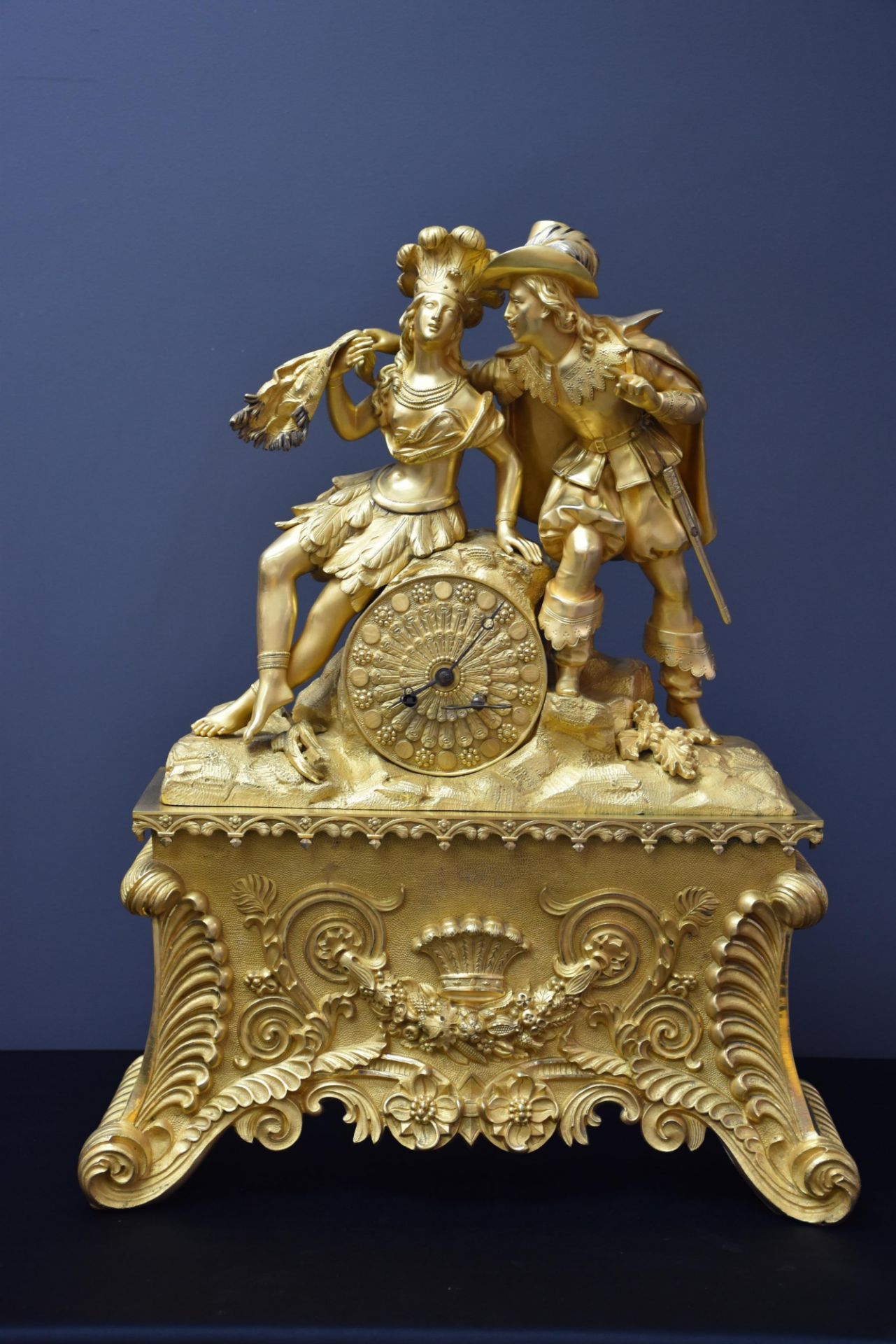 Gilt bronze clock circa 1830. The Amerindian and the colonist of the XVIIth century. Height : 51