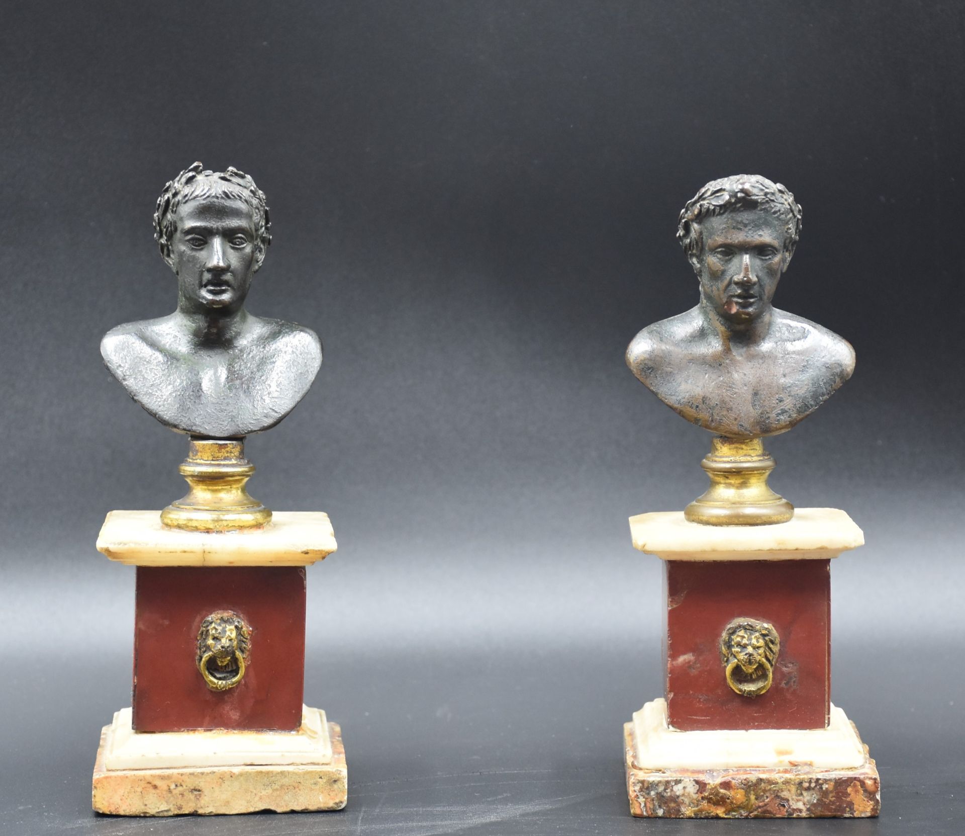 Pair of antique bronze busts on square marble bases composed of three different species. Bronze