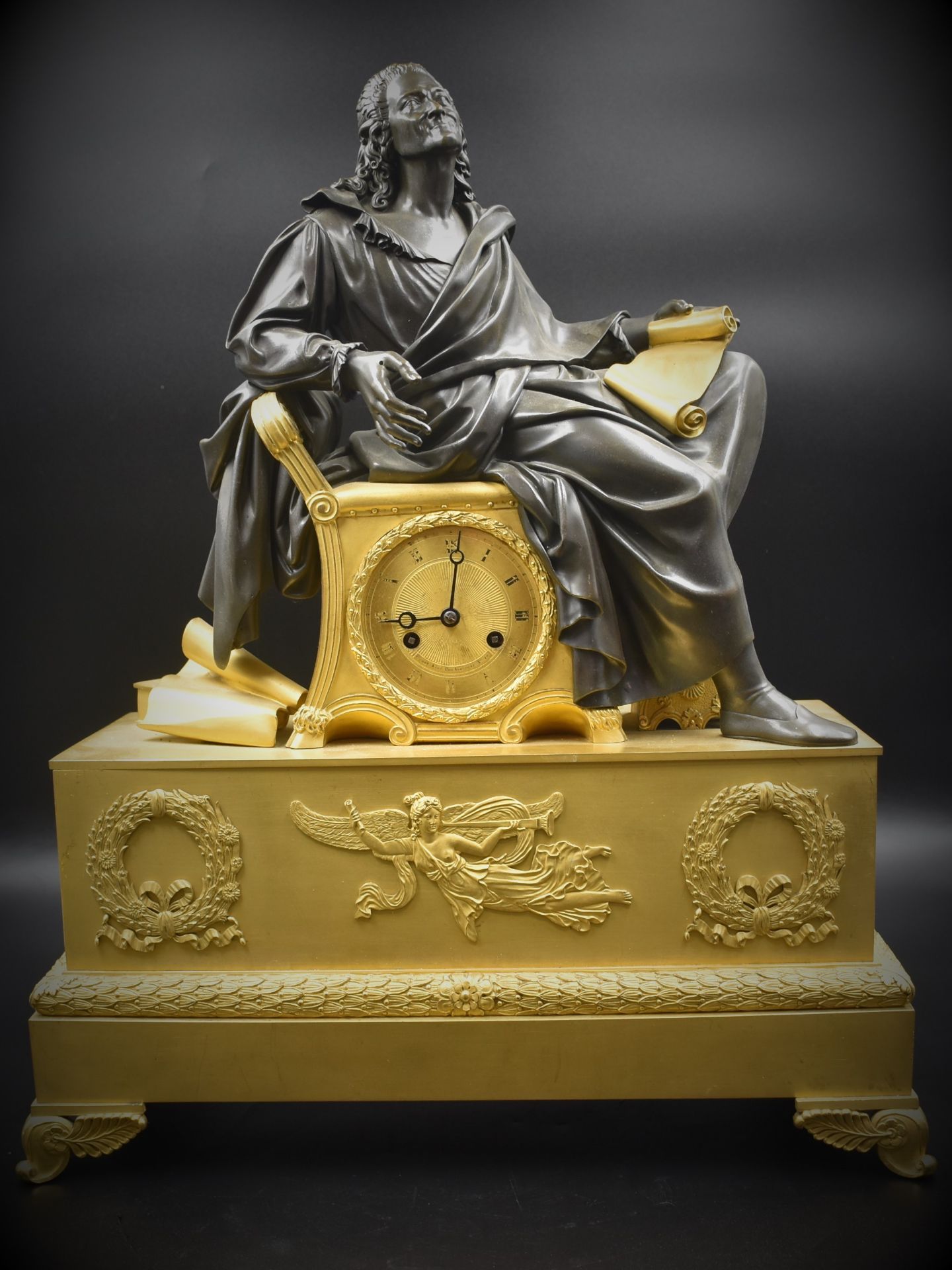 Restoration period clock in gilt and patinated bronze representing Voltaire. Small lack above the