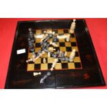 A vintage lacquered chess board & pieces (complete)