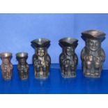 A set of five graduated bronzed toby jugs